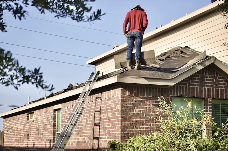 Professional roofer working on a residential roof in Neptune